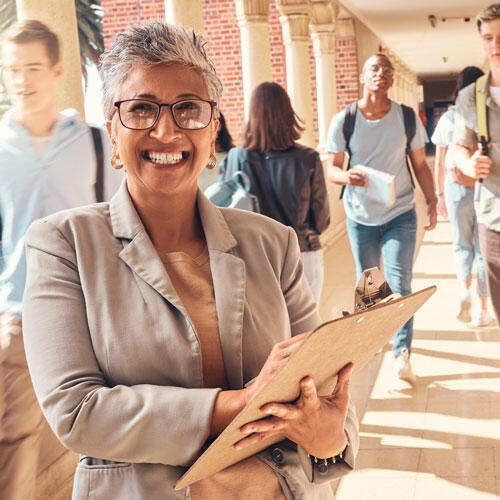 A school administrator standing in a hallway